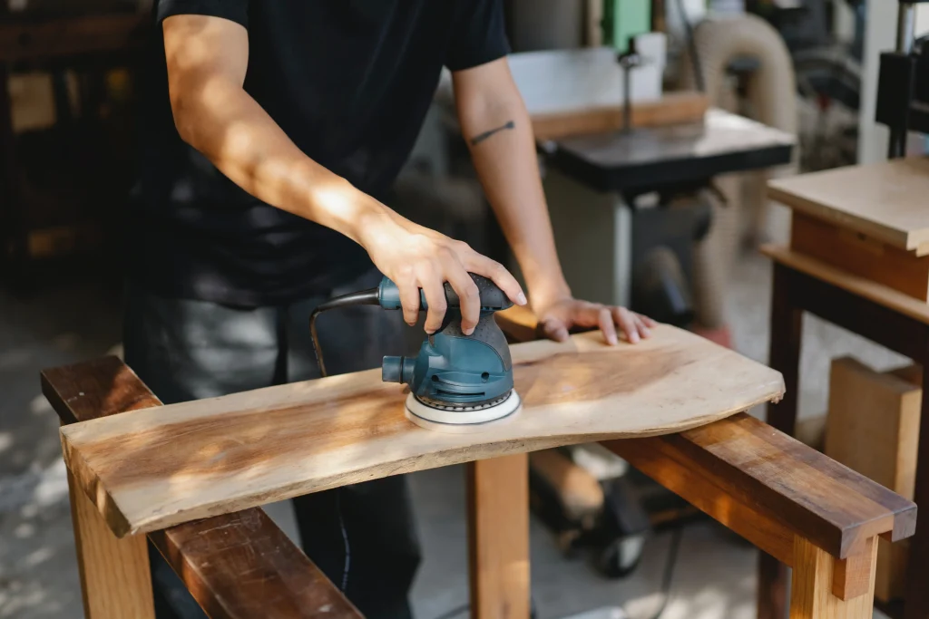Man working on polishing the wooden board