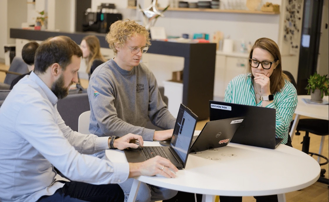 3 people working at the desk - Hire Abroad Founders