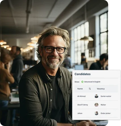 Man in office environment with people