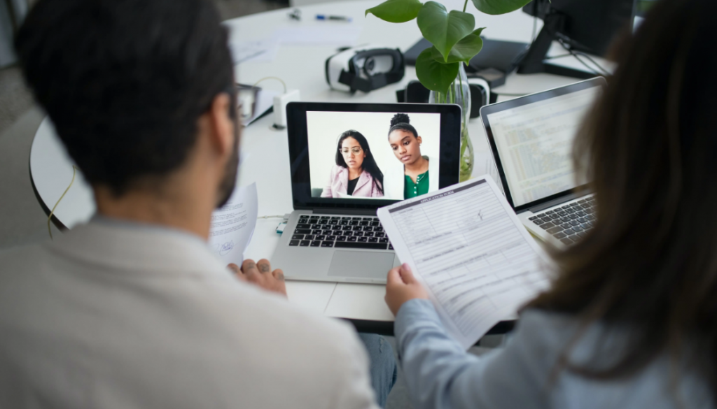 Recruiters looking at laptop screen