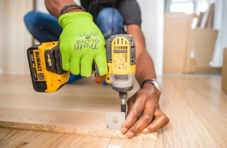 Man Drilling Hole in Wood