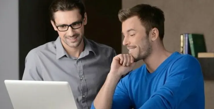 two male recruiters looking at laptop