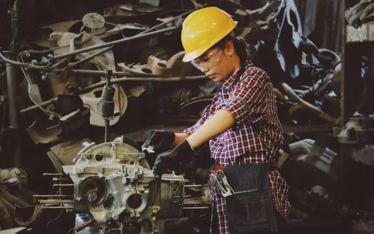 female worker working on car engine