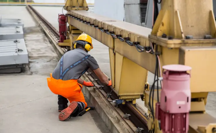 Blue-collar worker next to machine