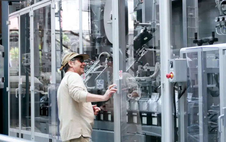Man in front of production machine