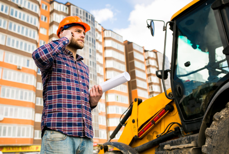 Construction worker on site speaking on phone