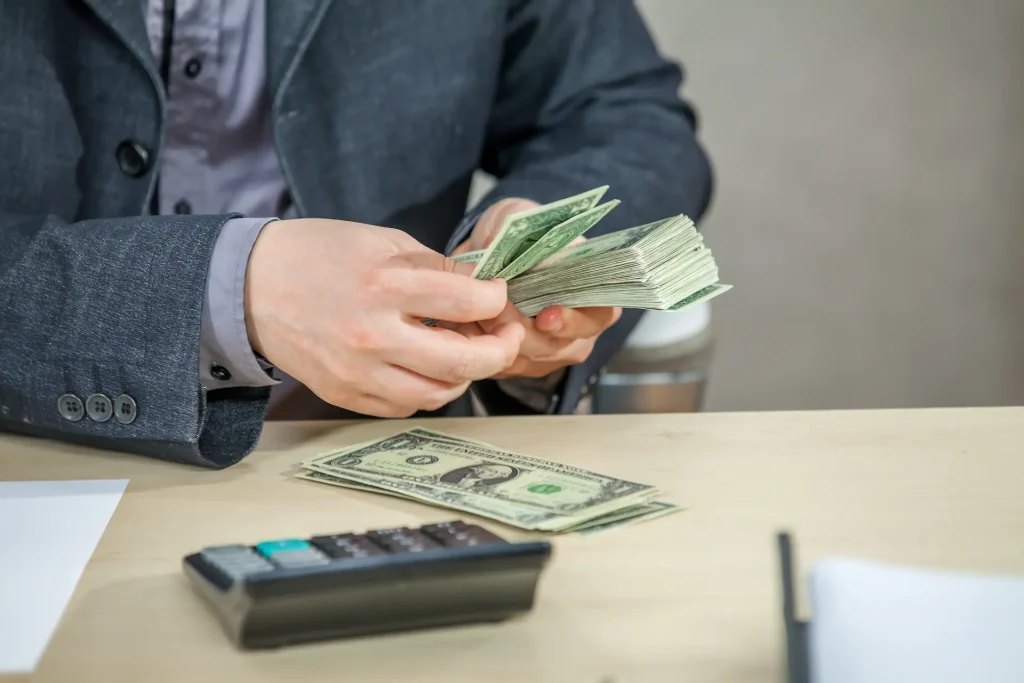 An illustration of recruiter holding cash in hands