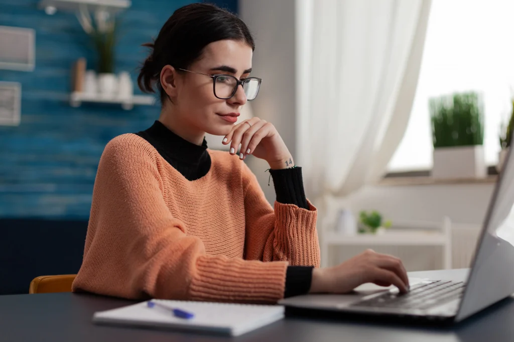 freelancer recruiter with glasses casually typing laptop keyboard