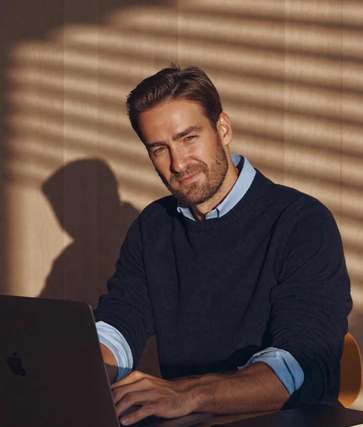 business man working behind his macbook