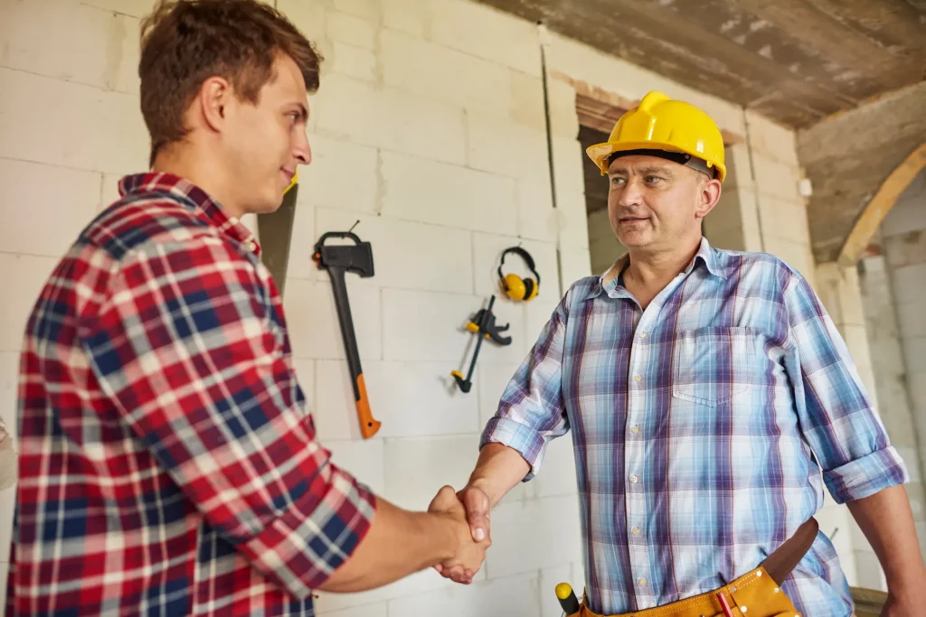 Worker shaking hands with recruiter.